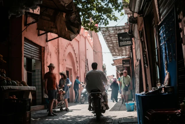 TukTuk Marrakech surrounded by colorful souk stalls